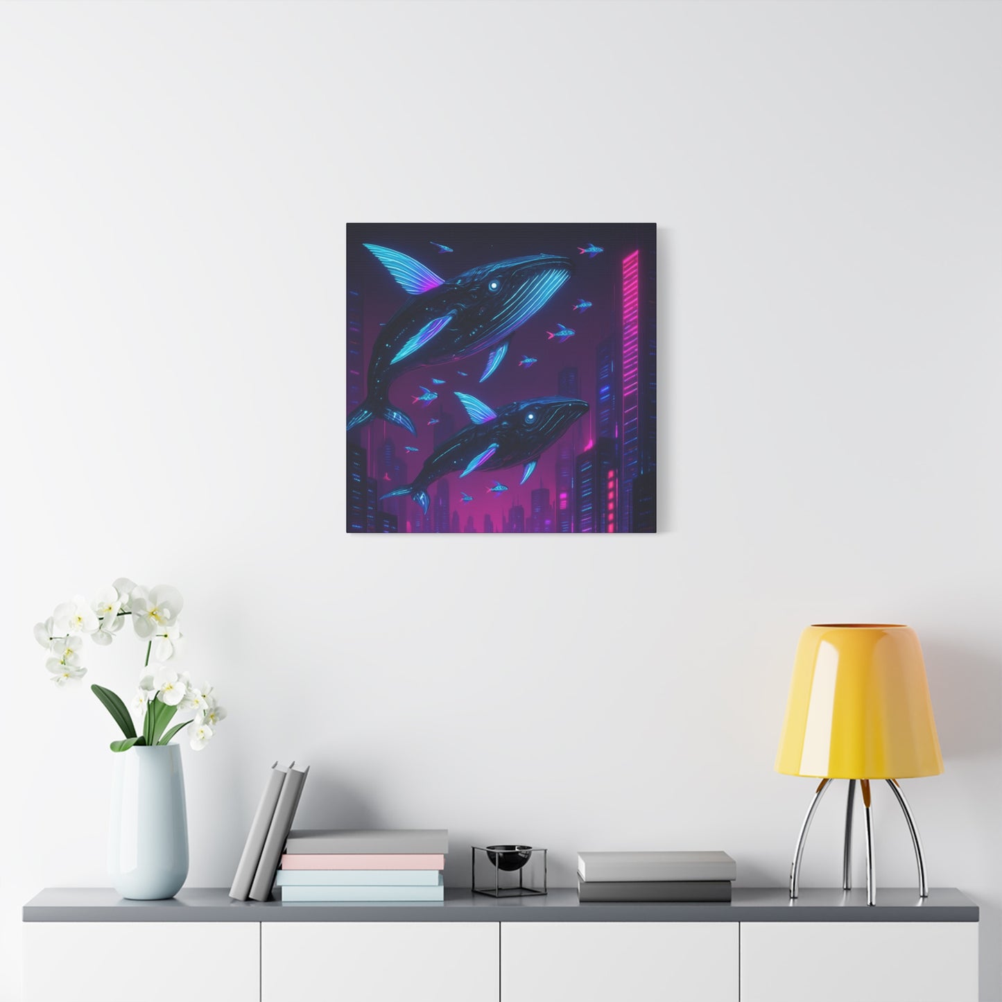 Framed artwork of whales on a wall above a shelf with decor items.