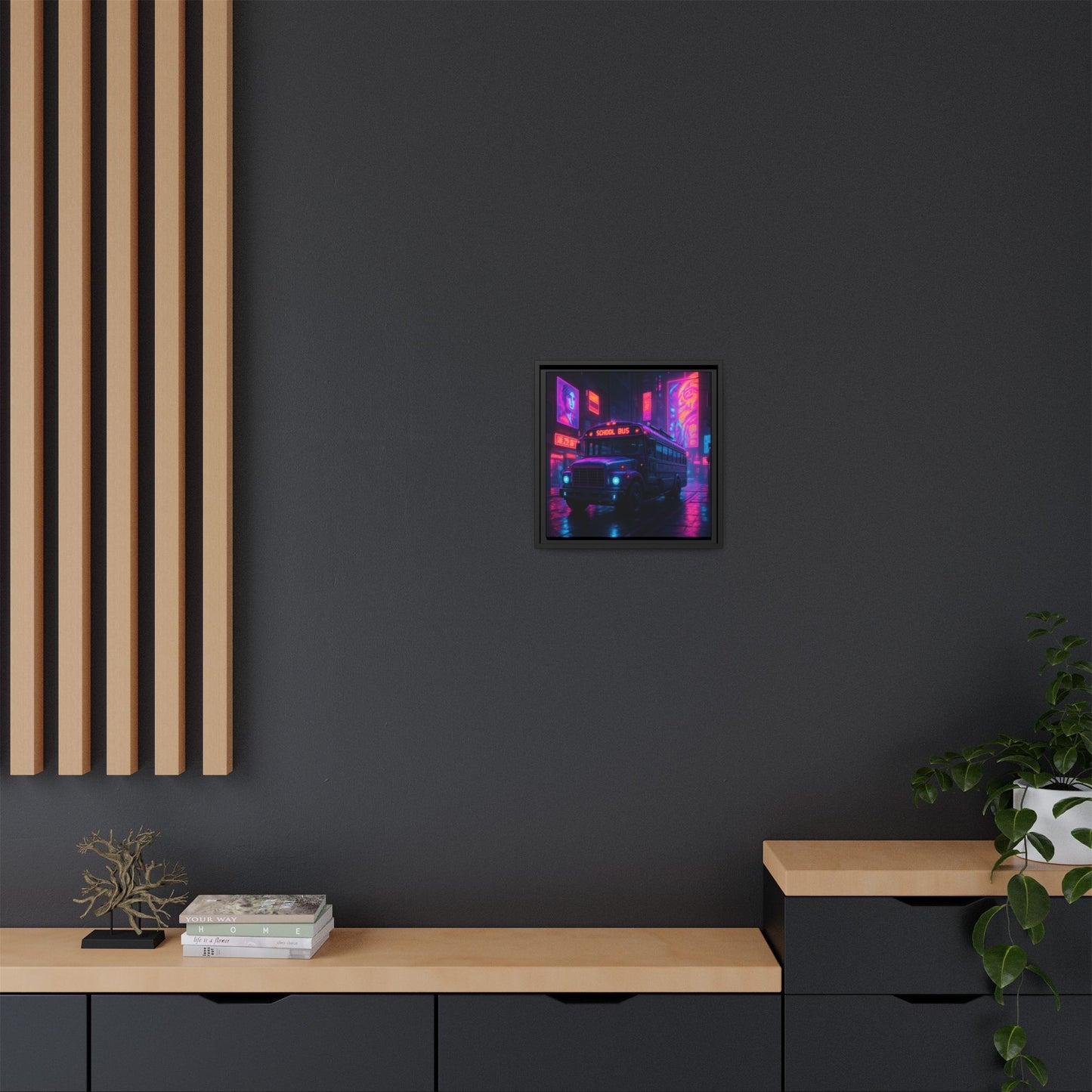 Framed abstract artwork on a dark wall with wooden furniture and plants.