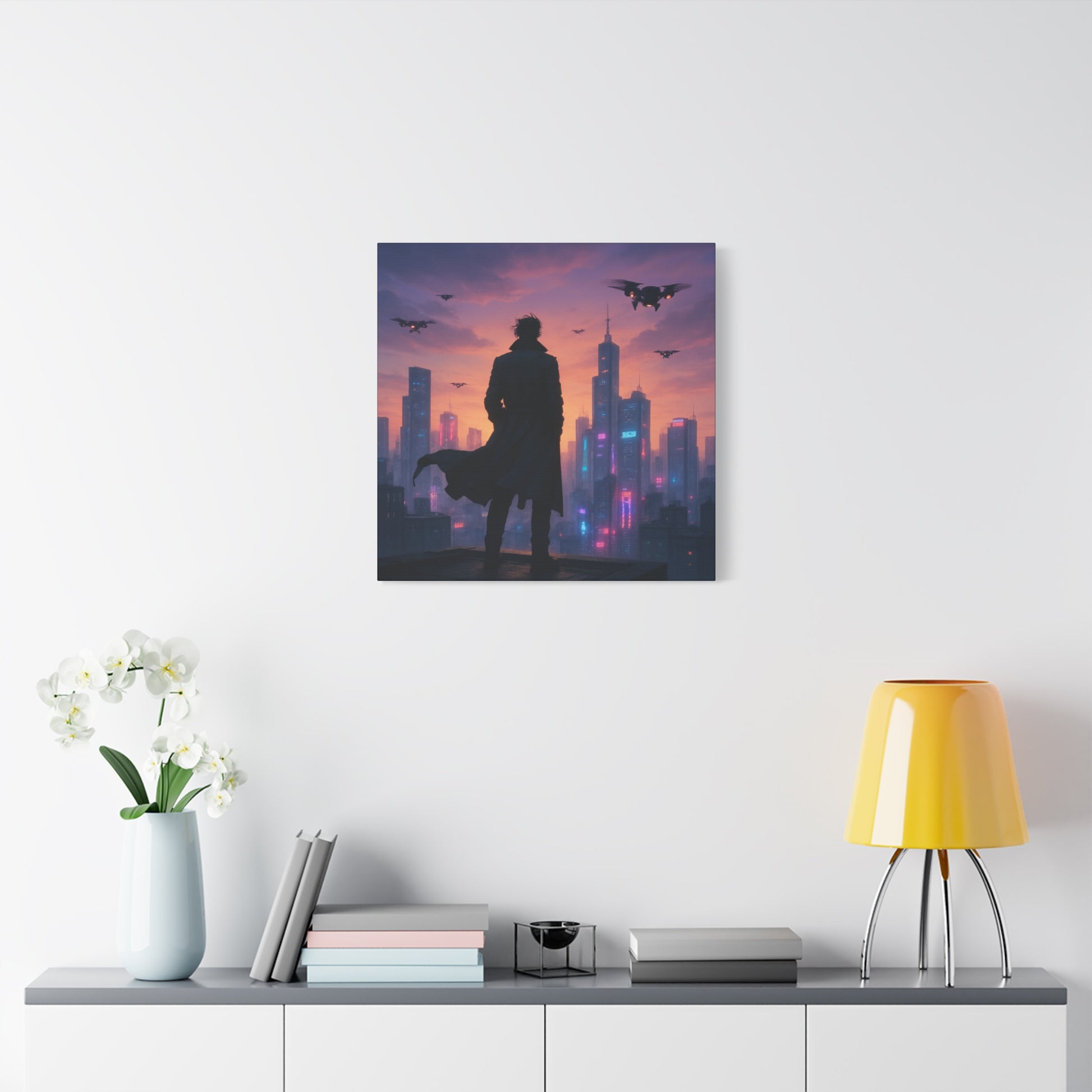 Framed artwork of a silhouette against a cityscape with a purple and pink sky, displayed on a wall above a shelf.